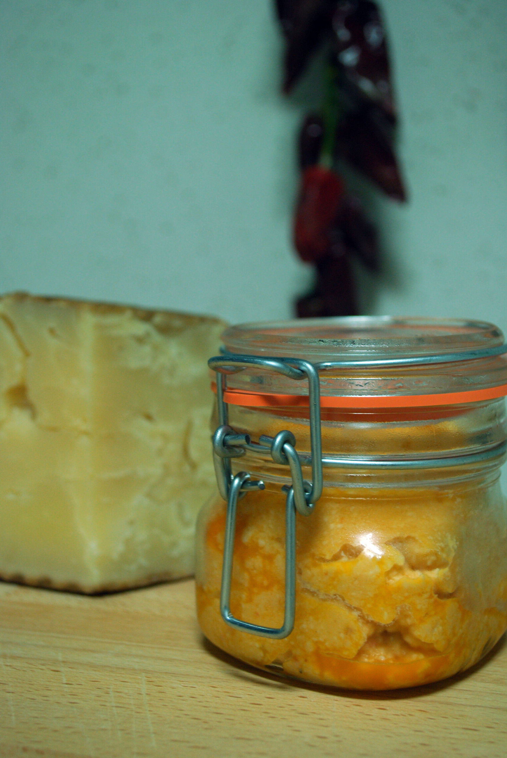 Almogrote, a traditional Canarian cheese spread made from aged cheese and peppers, shown in its characteristic jar alongside fresh cheese.