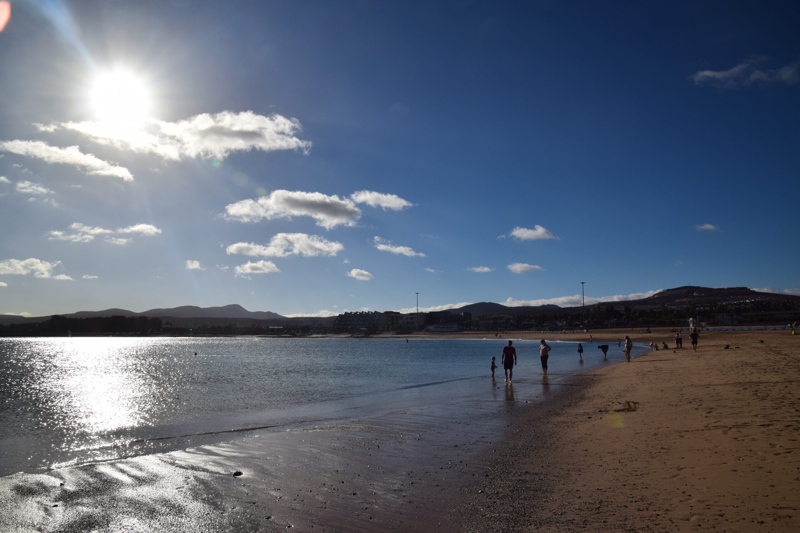 Castillo Beach in Caleta de Fuste offers calm, shallow waters ideal for swimming and relaxation beneath the Canarian sun.