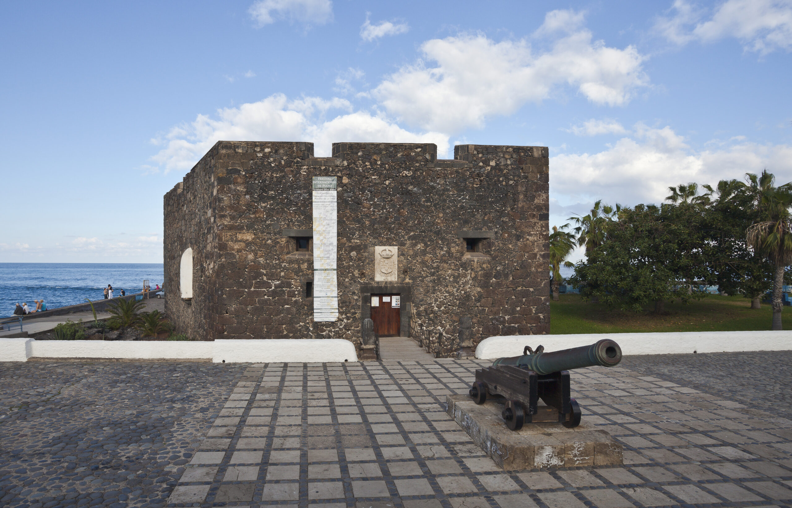 Castillo San Felipe, a 17th-century coastal fortress in Puerto de la Cruz, features distinctive dark volcanic stone walls and period cannons overlooking the Atlantic.