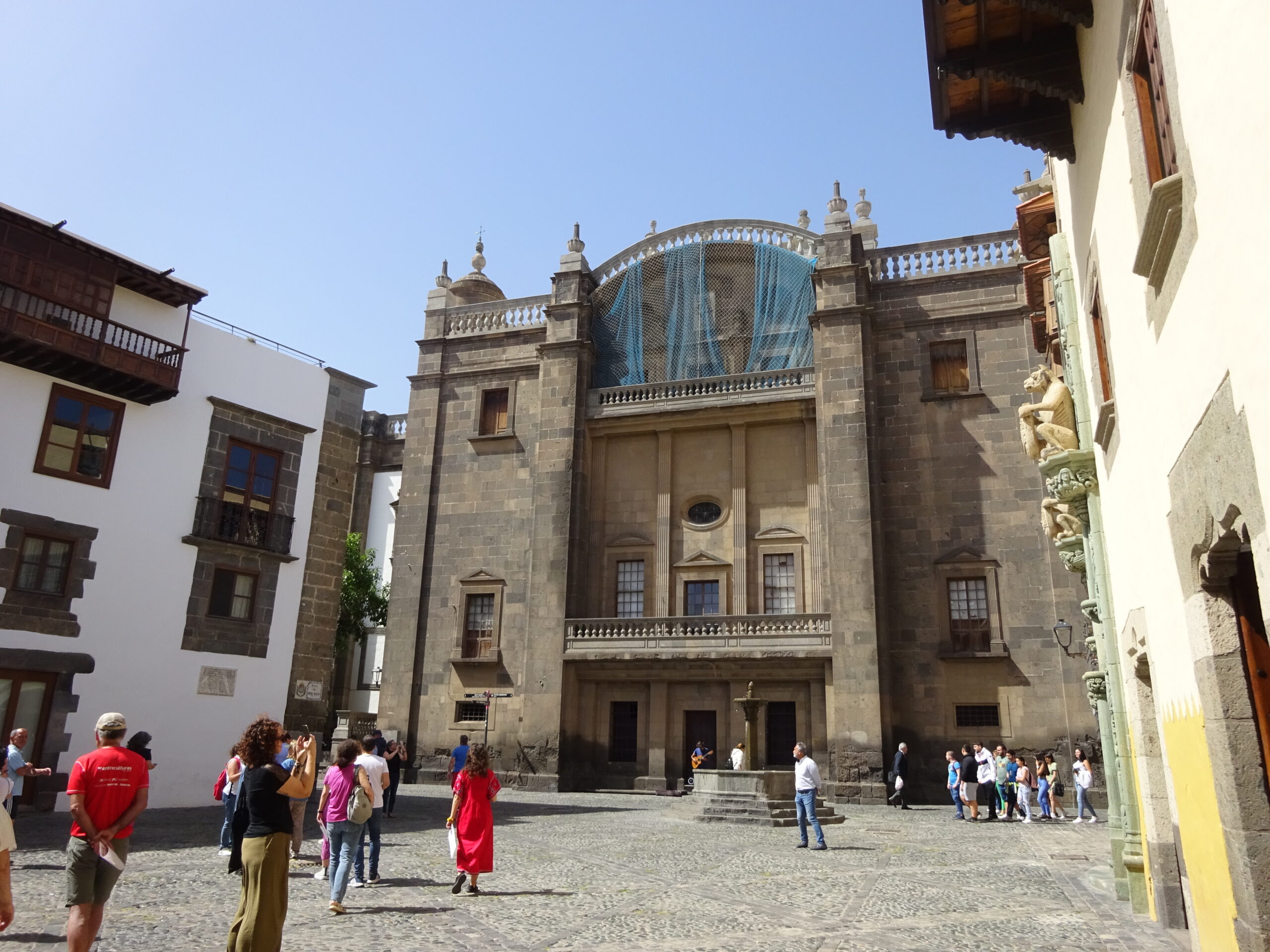 The façade of Santa Ana Cathedral in Las Palmas combines stonework with ornamental turquoise details, facing the cobbled plaza at the centre of Vegueta.