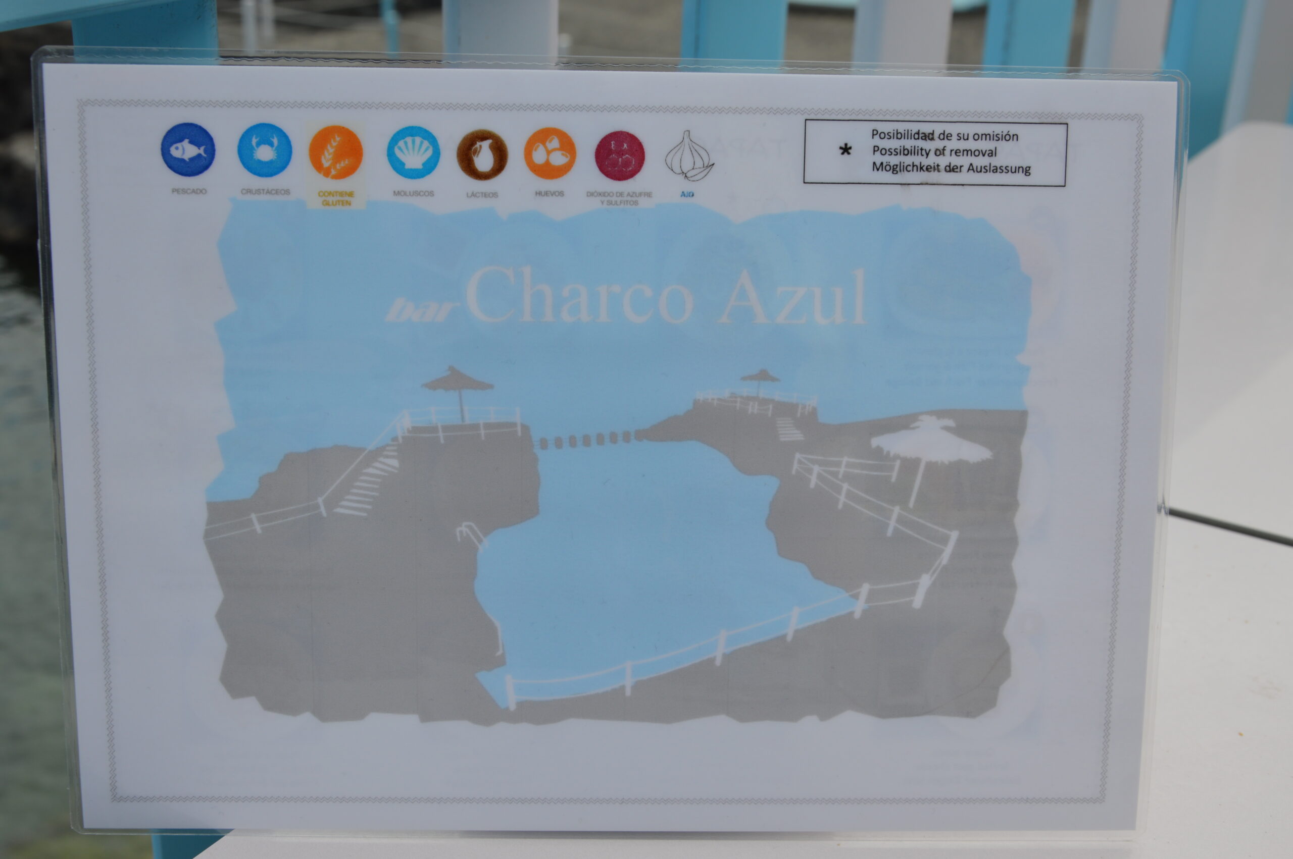 An interpretive sign displays the layout and amenities of Charco Azul, a natural pool attraction in San Andrés, La Palma.