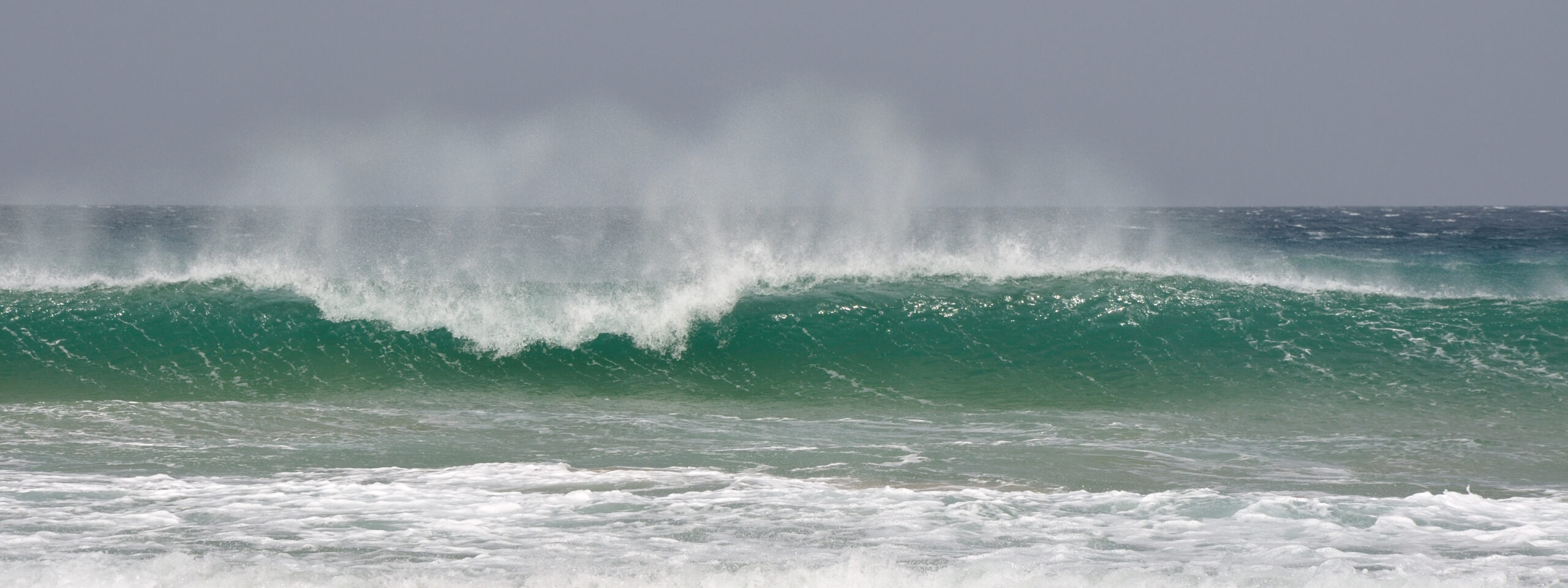 Powerful Atlantic swells roll onto Cofete Beach, where consistent waves and dramatic coastal conditions characterize this remote Fuerteventura shoreline.