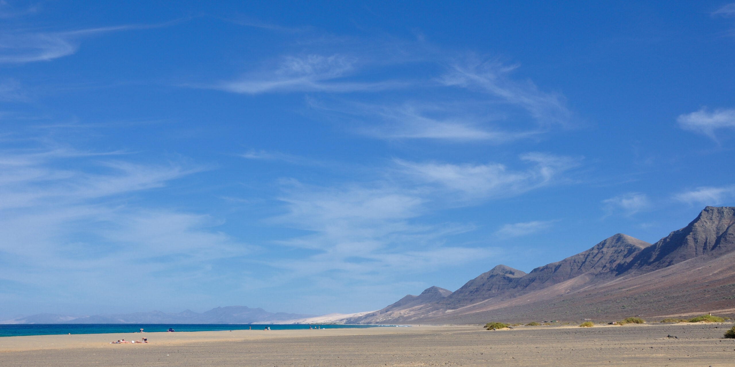 Cofete Beach stretches along Fuerteventura's southern coast, backed by the striking volcanic peaks of the Jandía peninsula.