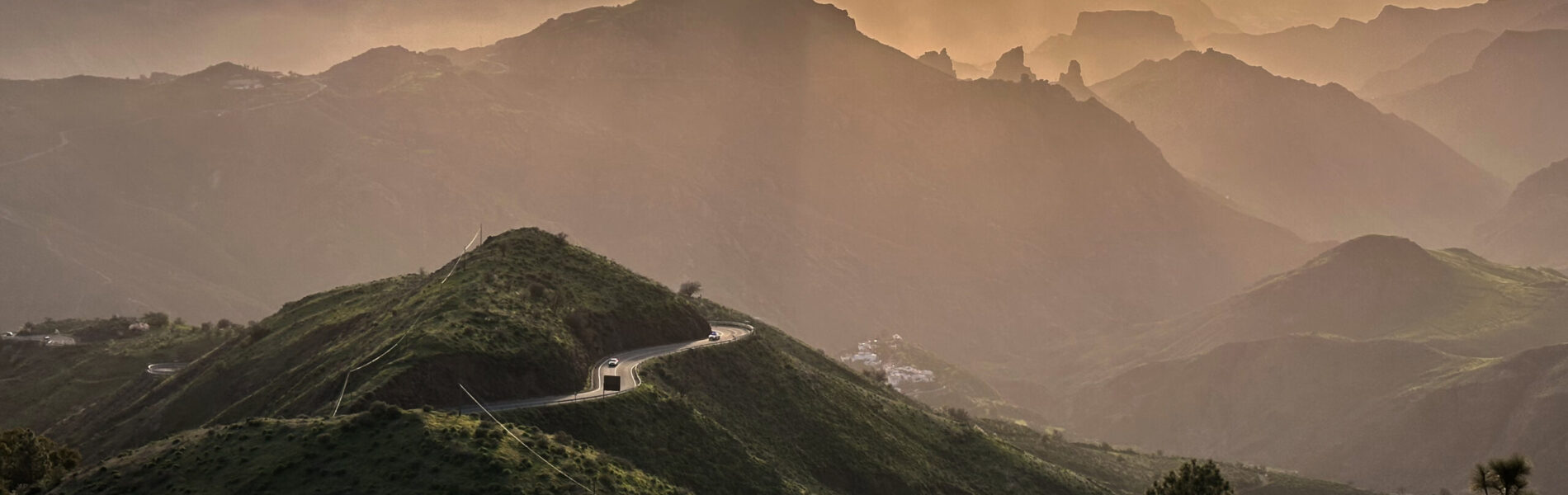 Sunrise over layered mountain ridges