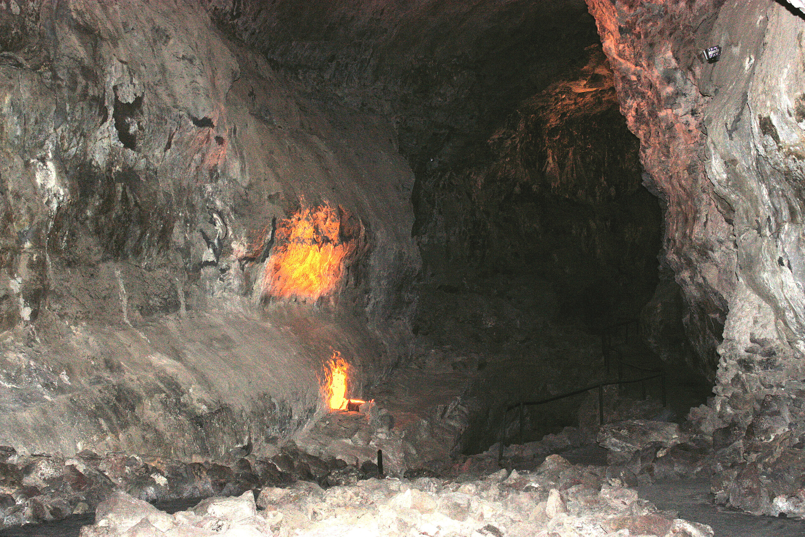 Natural gas vents burn continuously inside Cueva de los Verdes, a volcanic cave system in Lanzarote, creating an otherworldly display of fire against ancient lava formations.