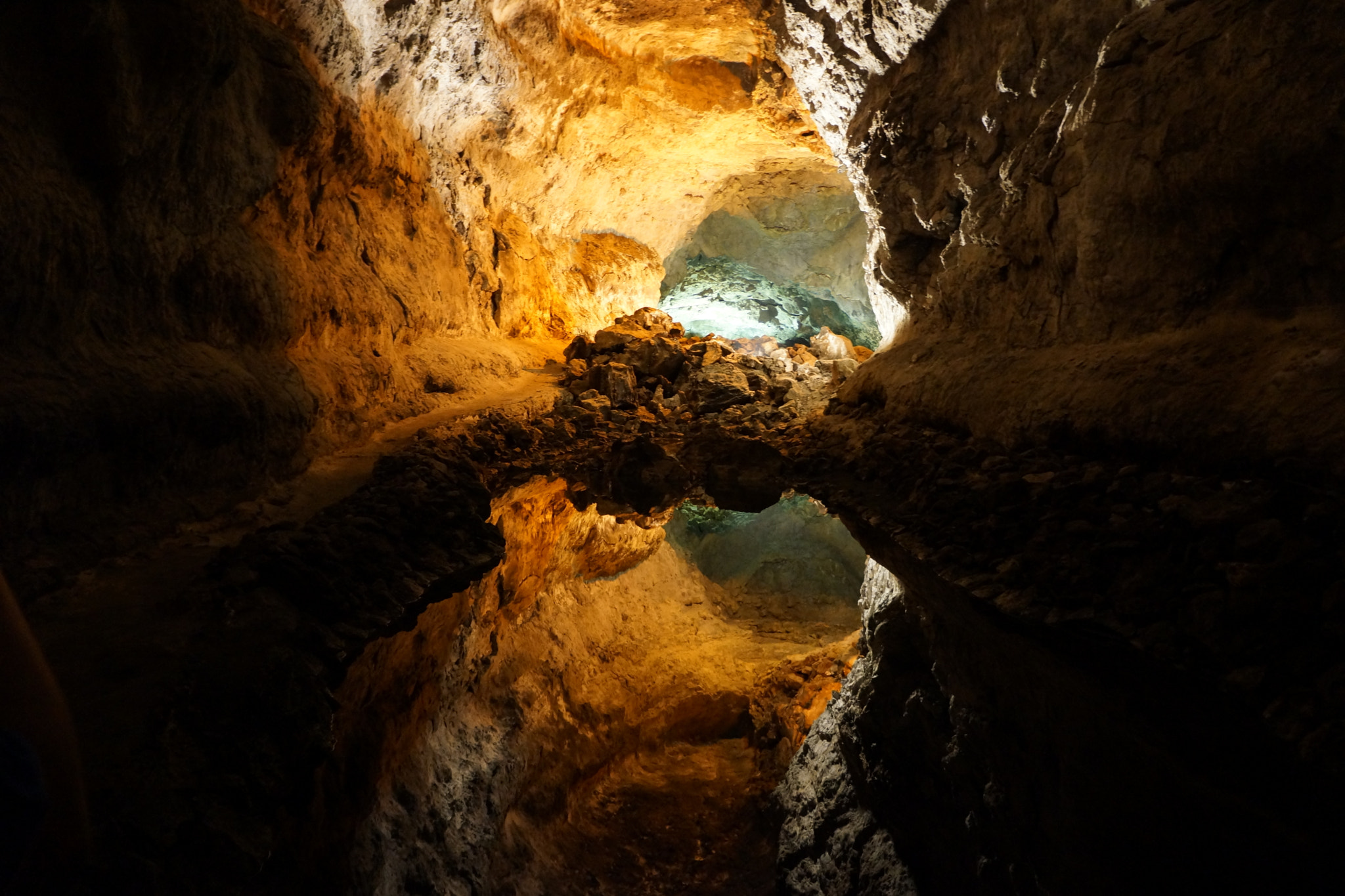 The striking golden walls and underground pool of Cueva de los Verdes showcase the volcanic geology of Lanzarote's famous lava tube cave.
