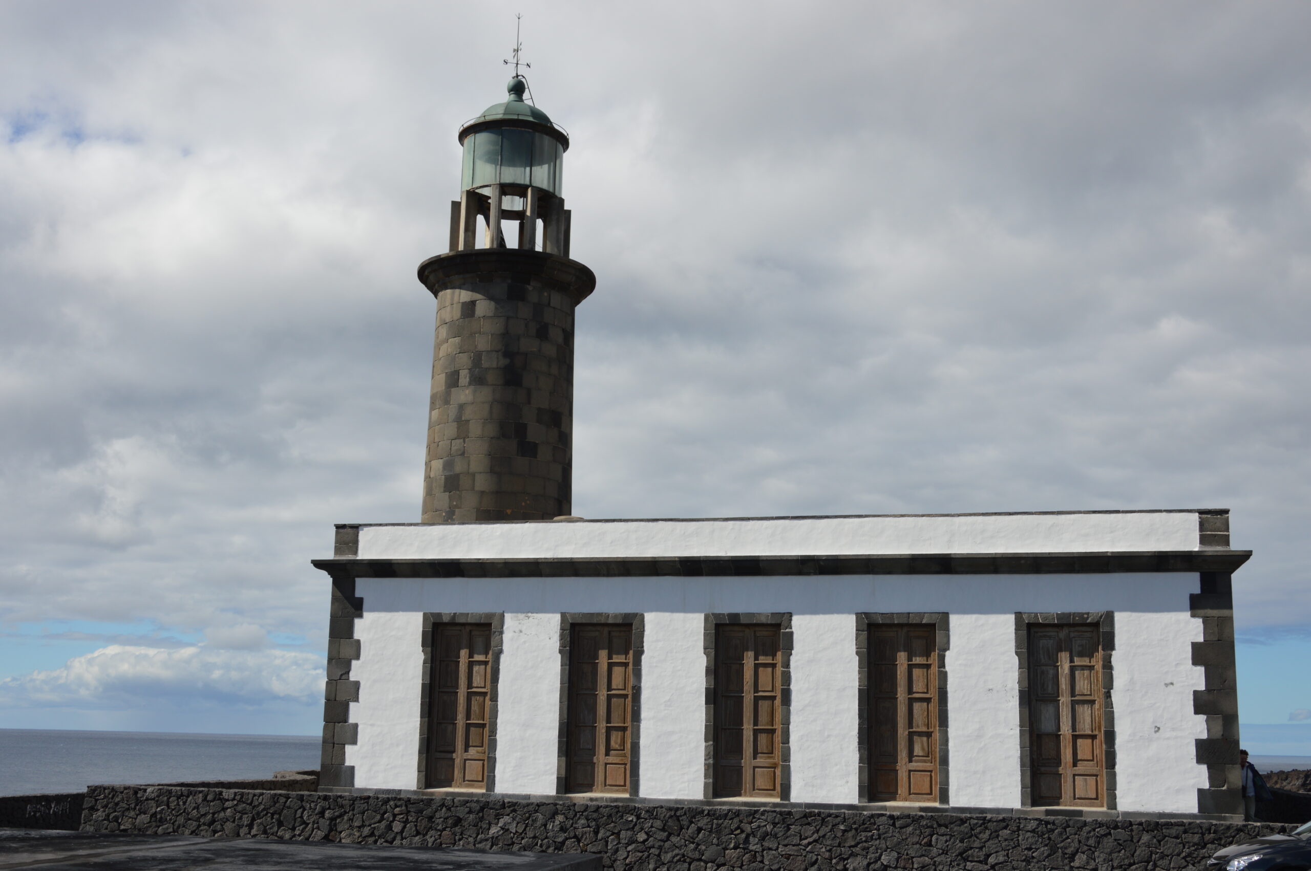 Faro de Fuencaliente, a distinctive 19th-century lighthouse with its attached keeper's quarters overlooking the southern coast of La Palma.