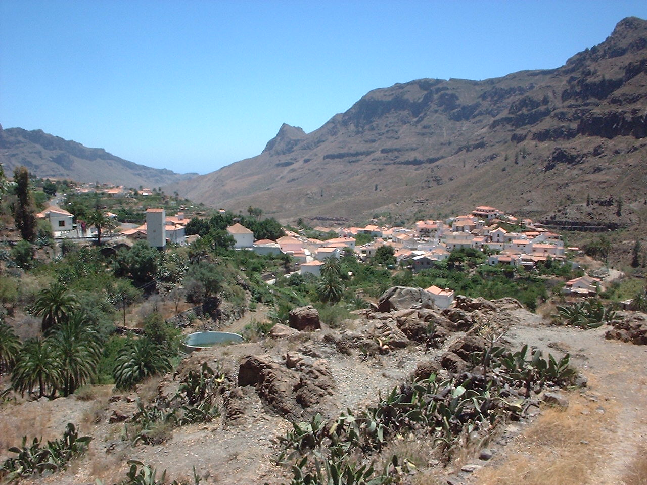 Fataga village spreads across the Caldera de Tirajana valley, with traditional architecture set against the dramatic volcanic landscape of Gran Canaria.