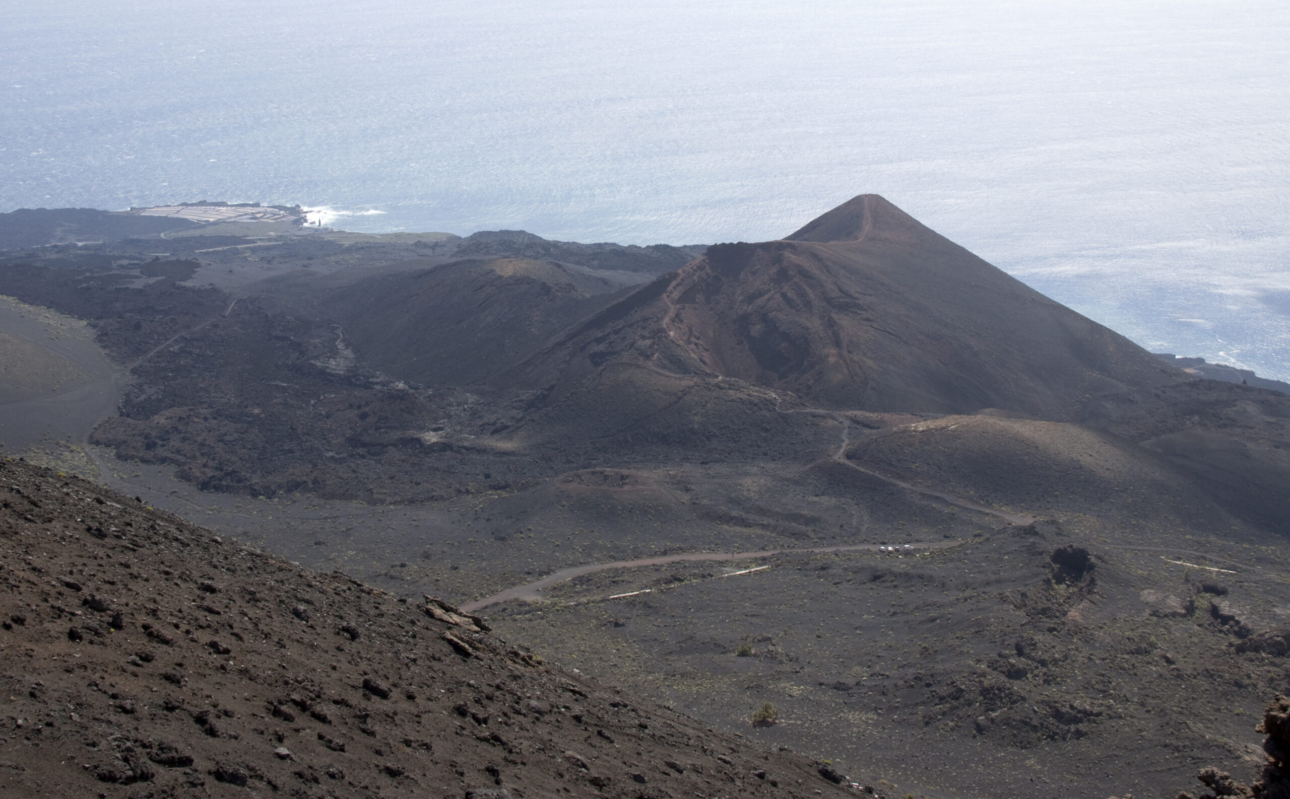 The volcanic landscape of Fuencaliente on La Palma, with distinctive cinder cones rising above expanses of dark lava flows.