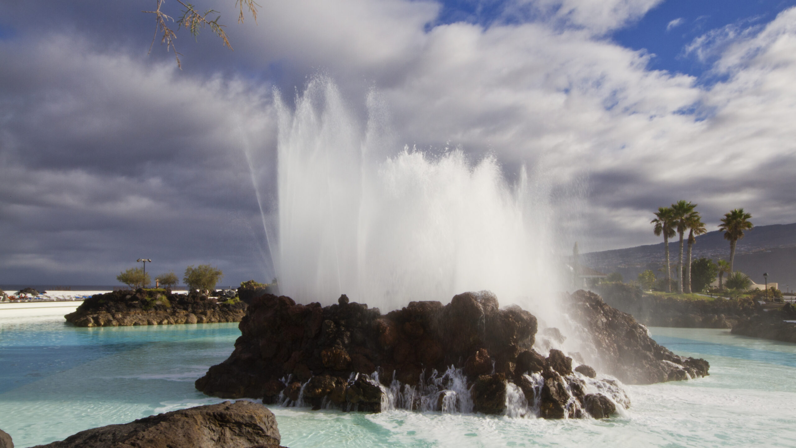 Dramatic Atlantic waves collide with volcanic rock formations in the turquoise waters of Lago Martiánez.