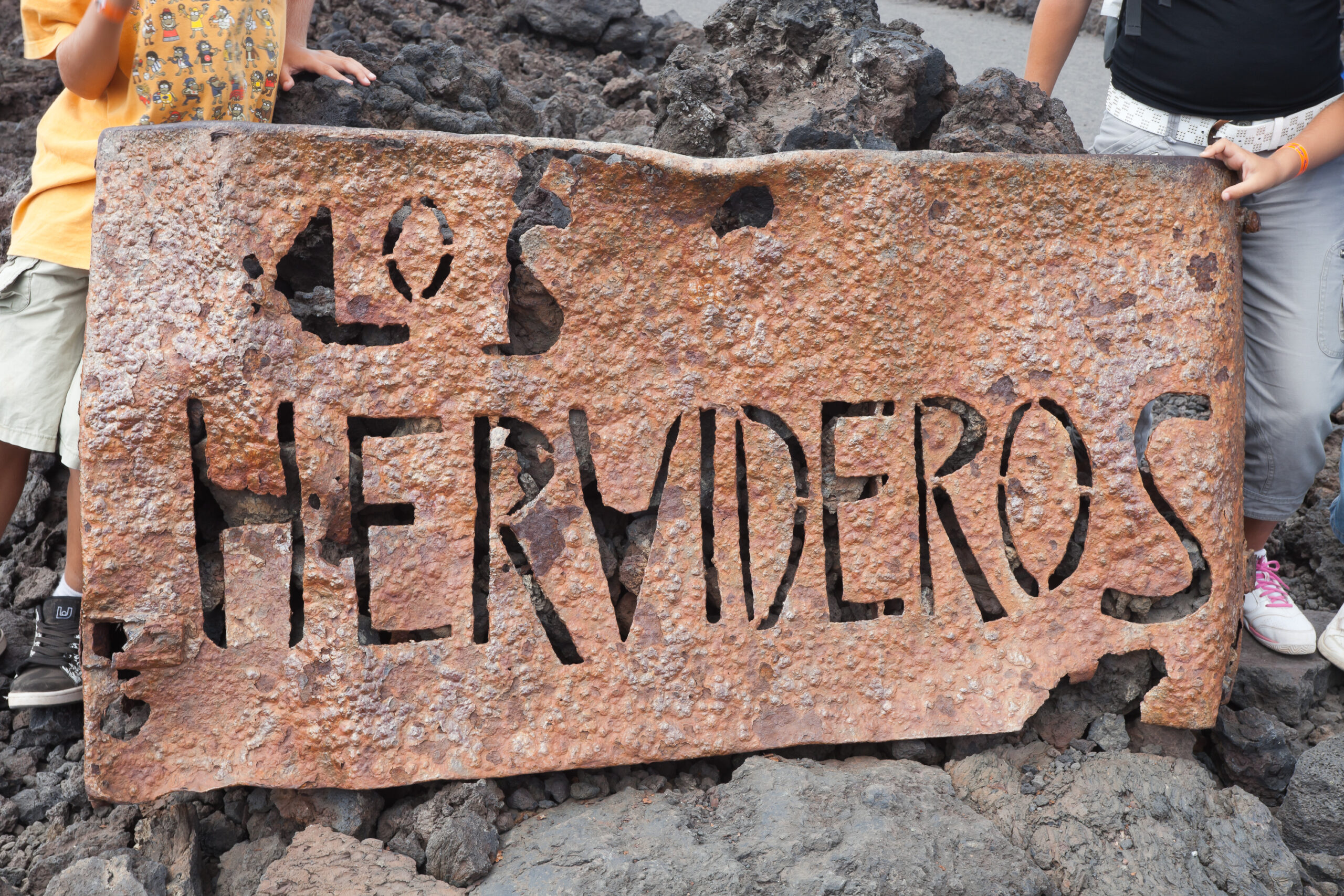 The Los Hervideros sign marks this dramatic volcanic landscape attraction on Lanzarote's western coast.