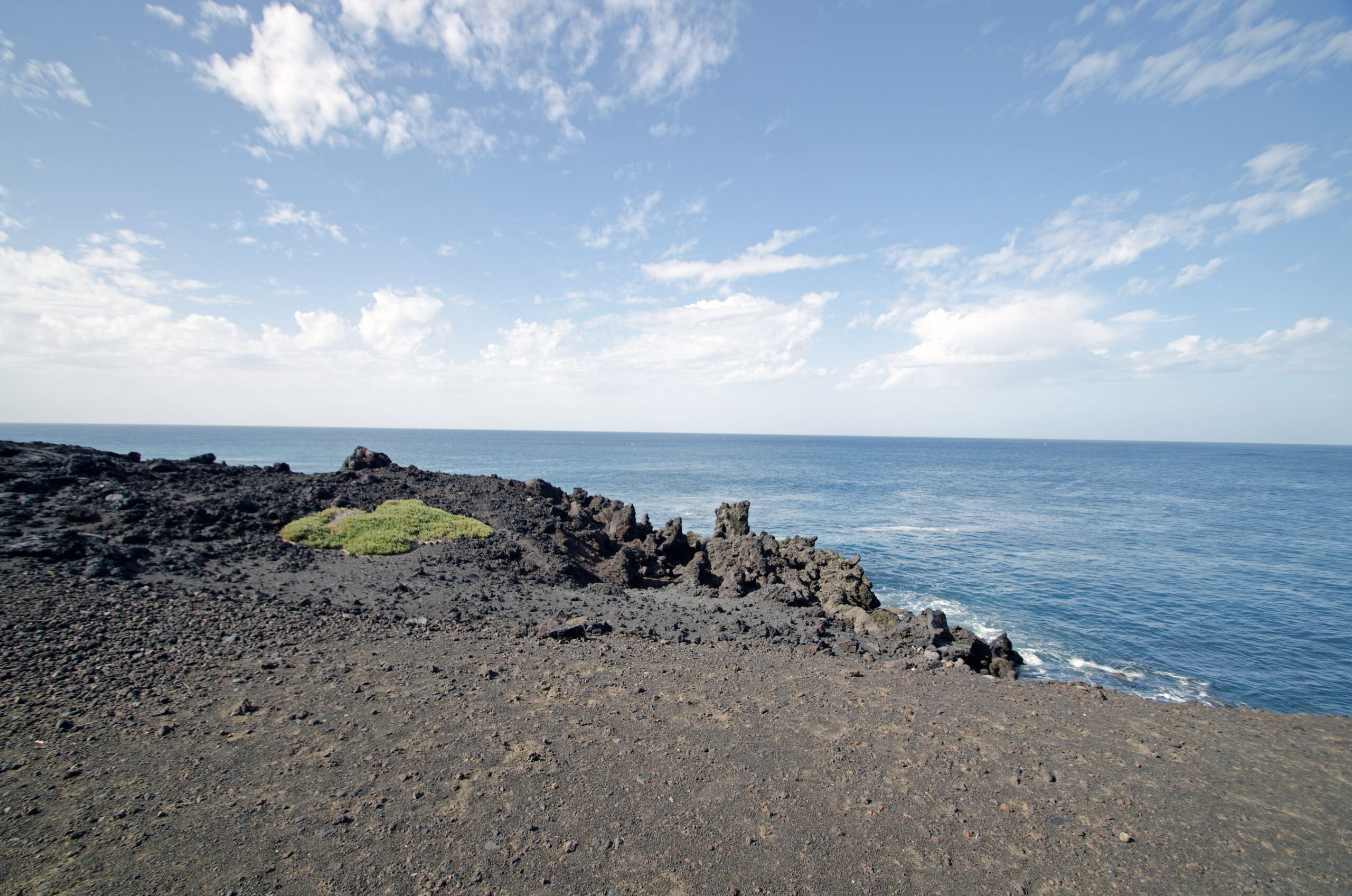Los Hervideros features dramatic volcanic rock outcrops and dark lava terrain along Lanzarote's rugged coastline.