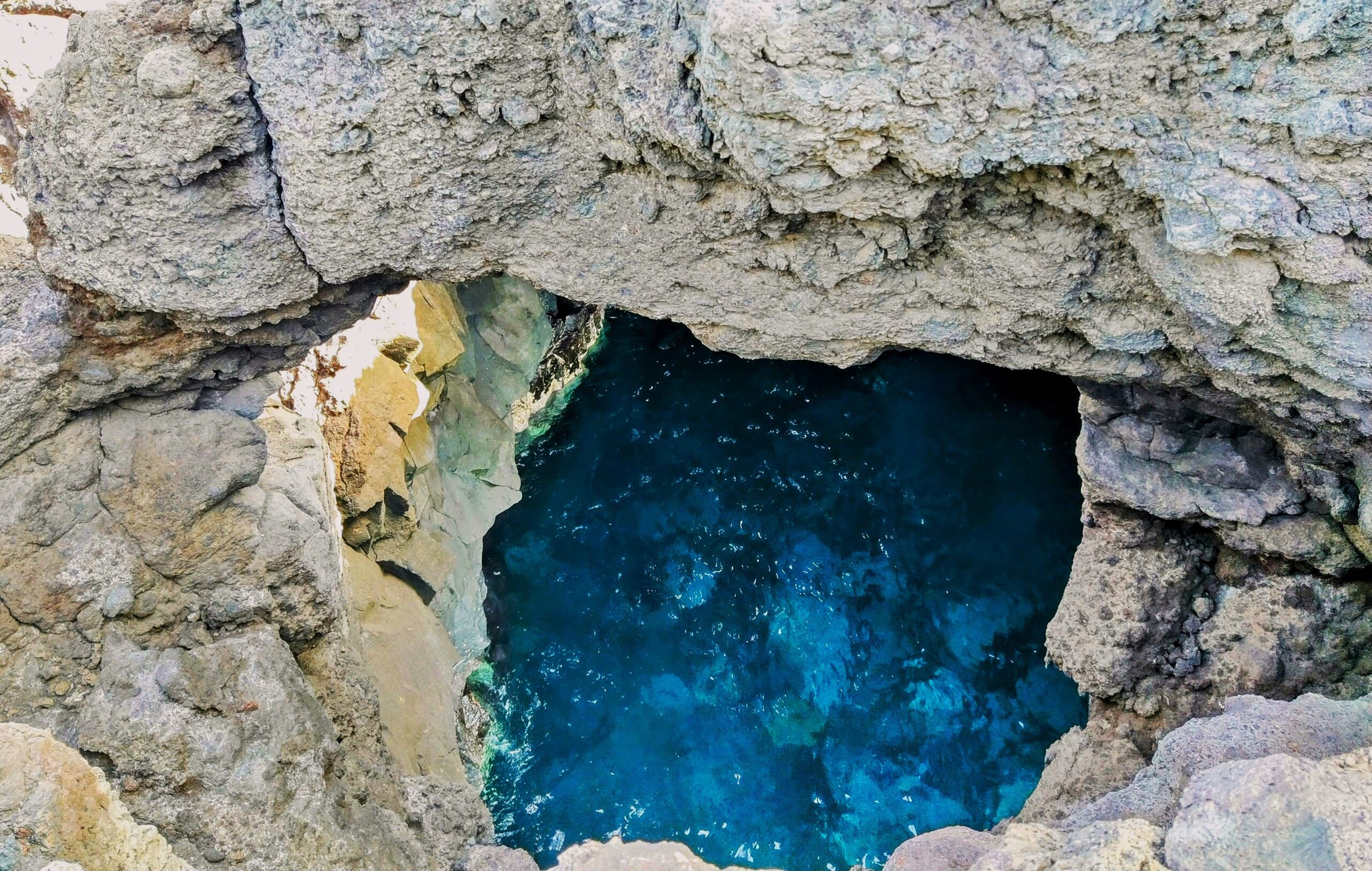 Deep pools of crystalline seawater nestle within the dramatic limestone formations at Los Hervideros, where volcanic geology meets the Atlantic.