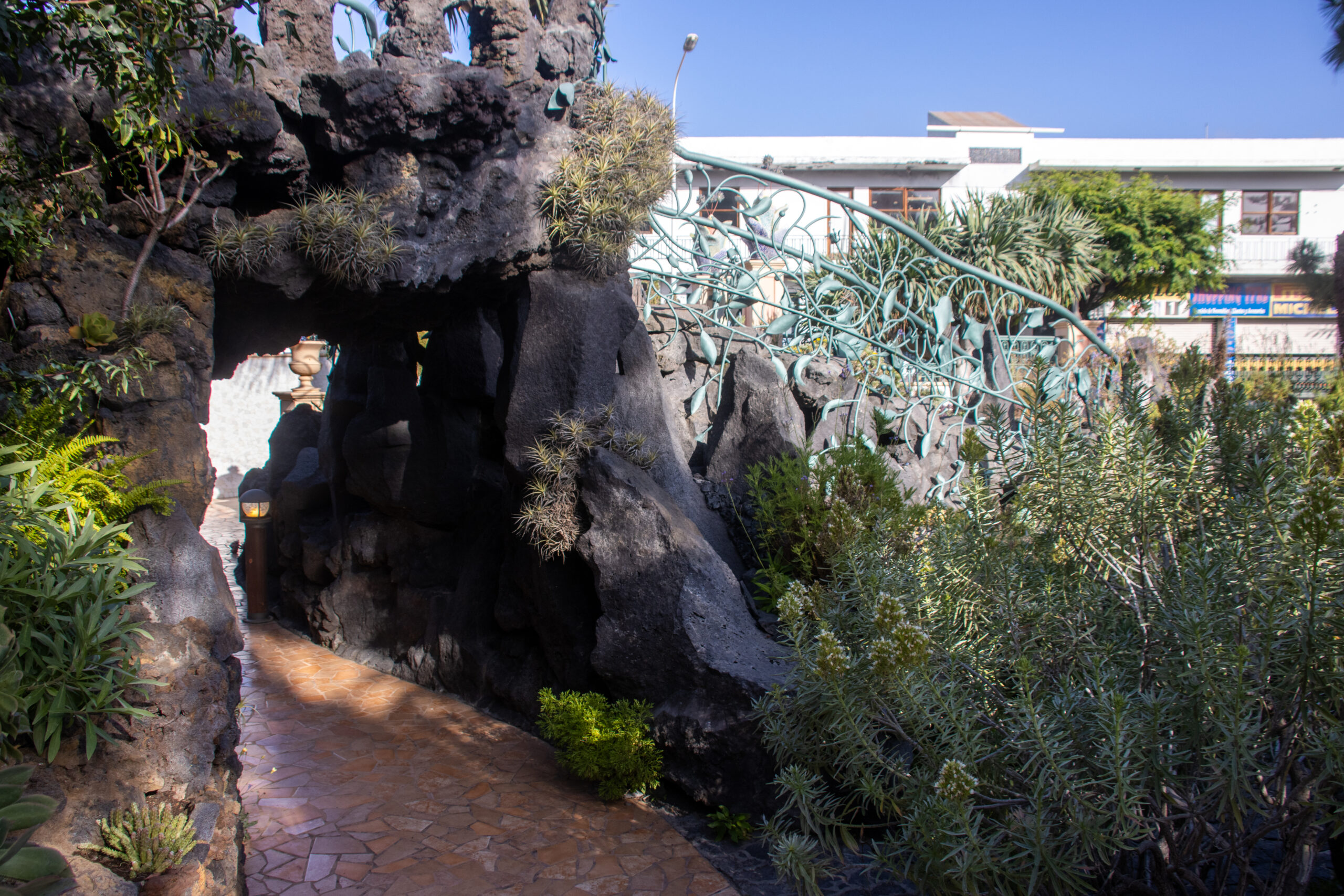 A dramatic natural rock tunnel in Los Llanos de Aridane, carved through volcanic stone and framed by lush vegetation.