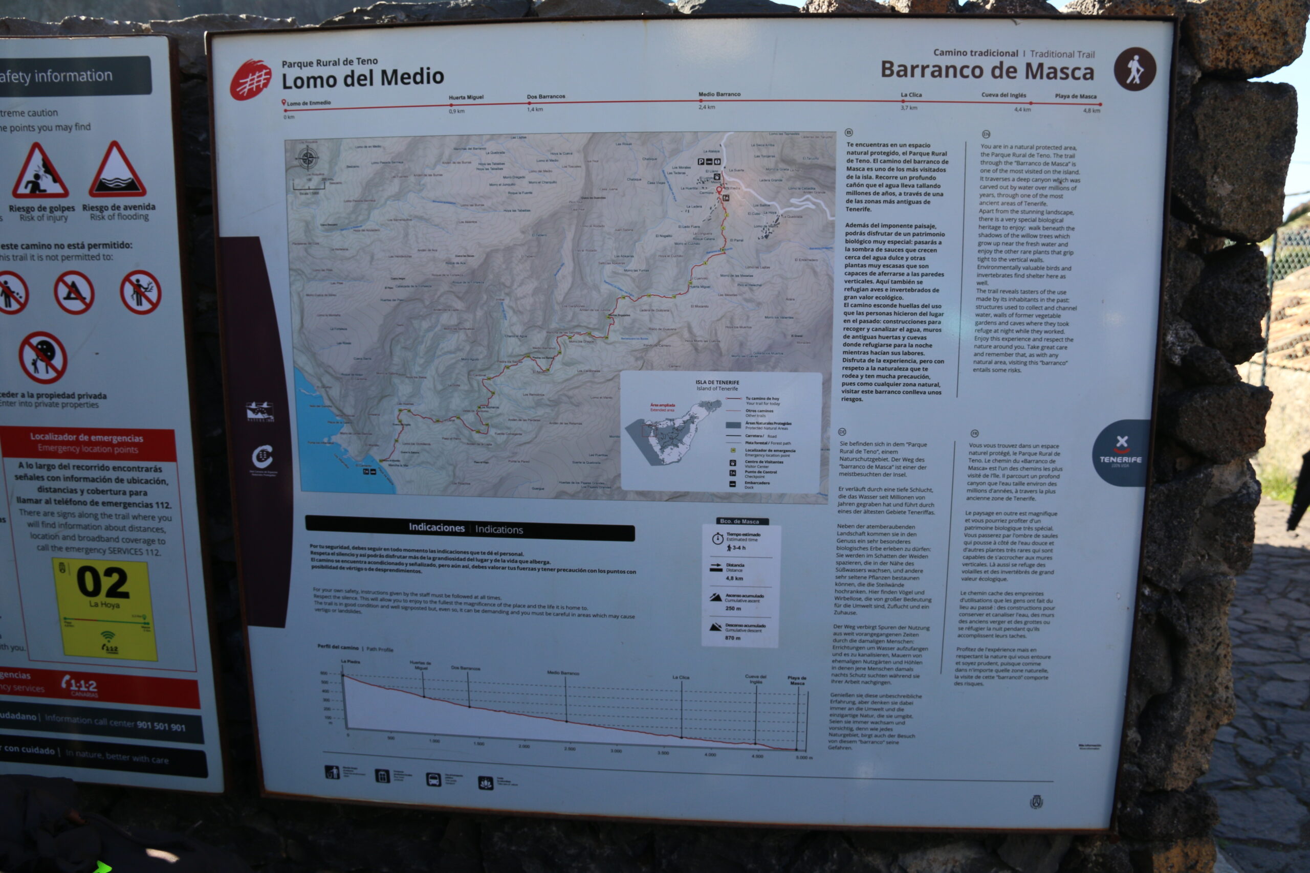 Interpretive signage at the trailhead displays the route map, elevation profile, and essential information for the Masca Trail hiking area.