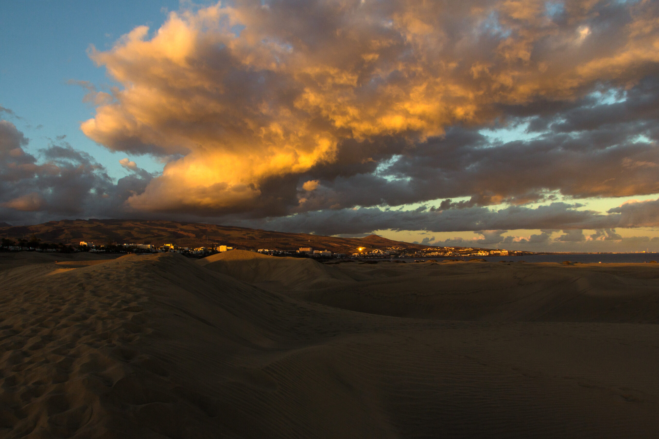 Sunset brings warm tones and long shadows across the Maspalomas Dunes.