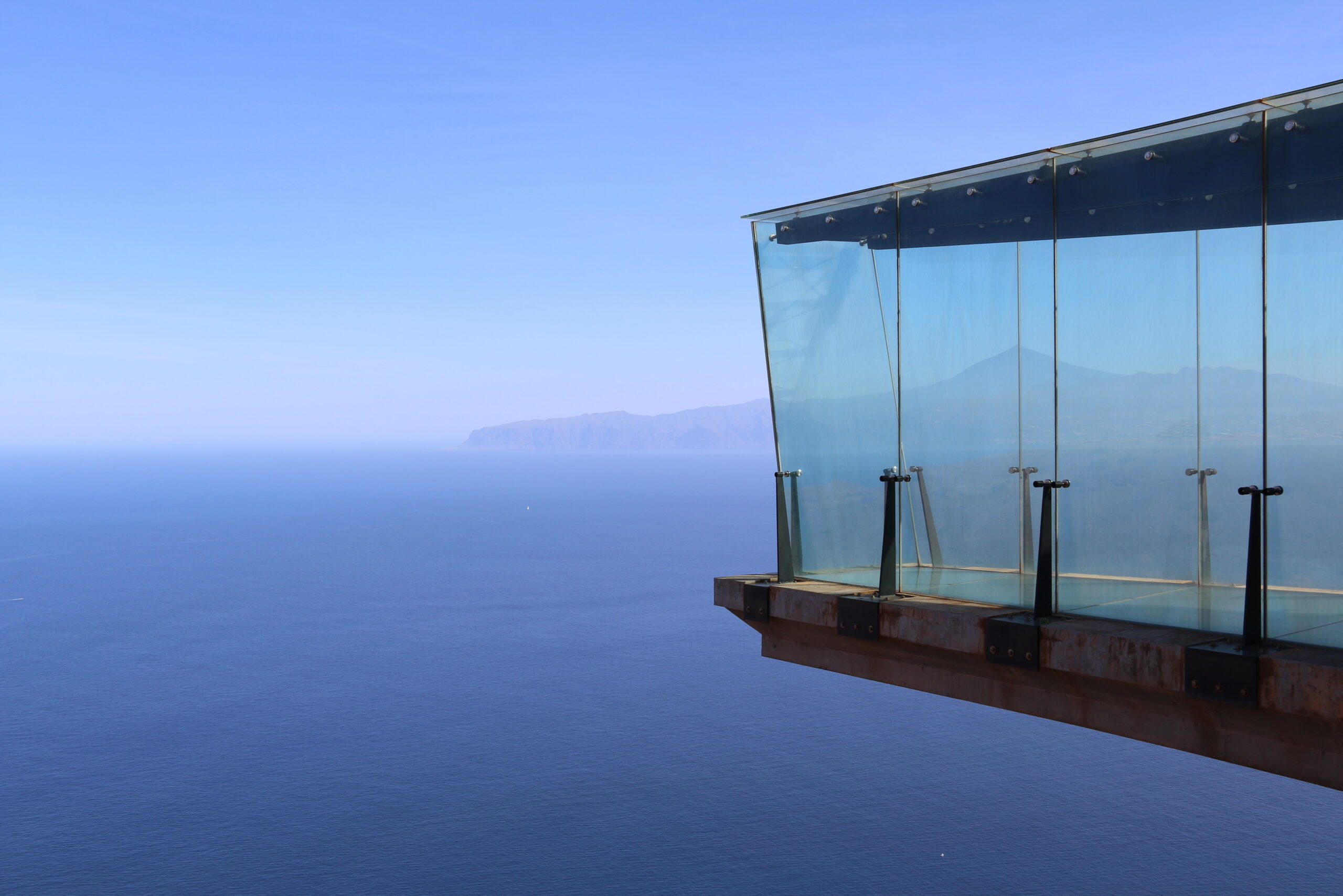 The Mirador de Abrante offers panoramic views across the Atlantic toward neighboring islands, with its distinctive glass structure providing unobstructed vistas from the clifftop.