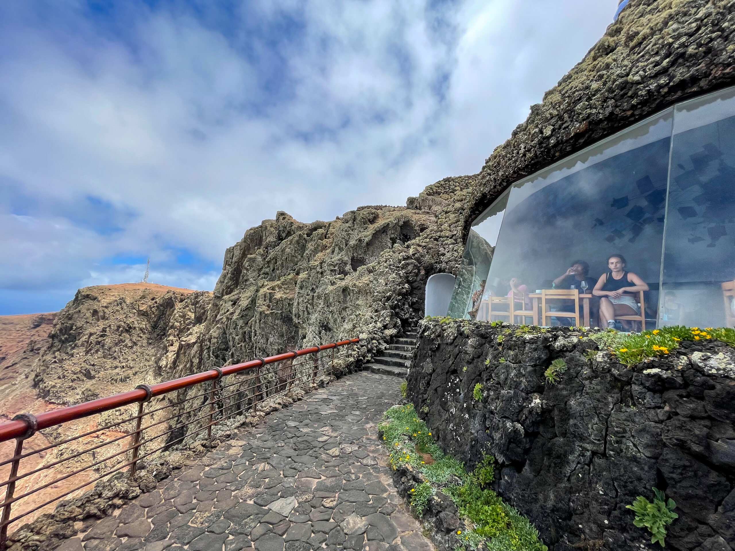 The Mirador del Río viewpoint, designed into the dramatic volcanic cliffs of Lanzarote's northern coast, offers panoramic views across the landscape.