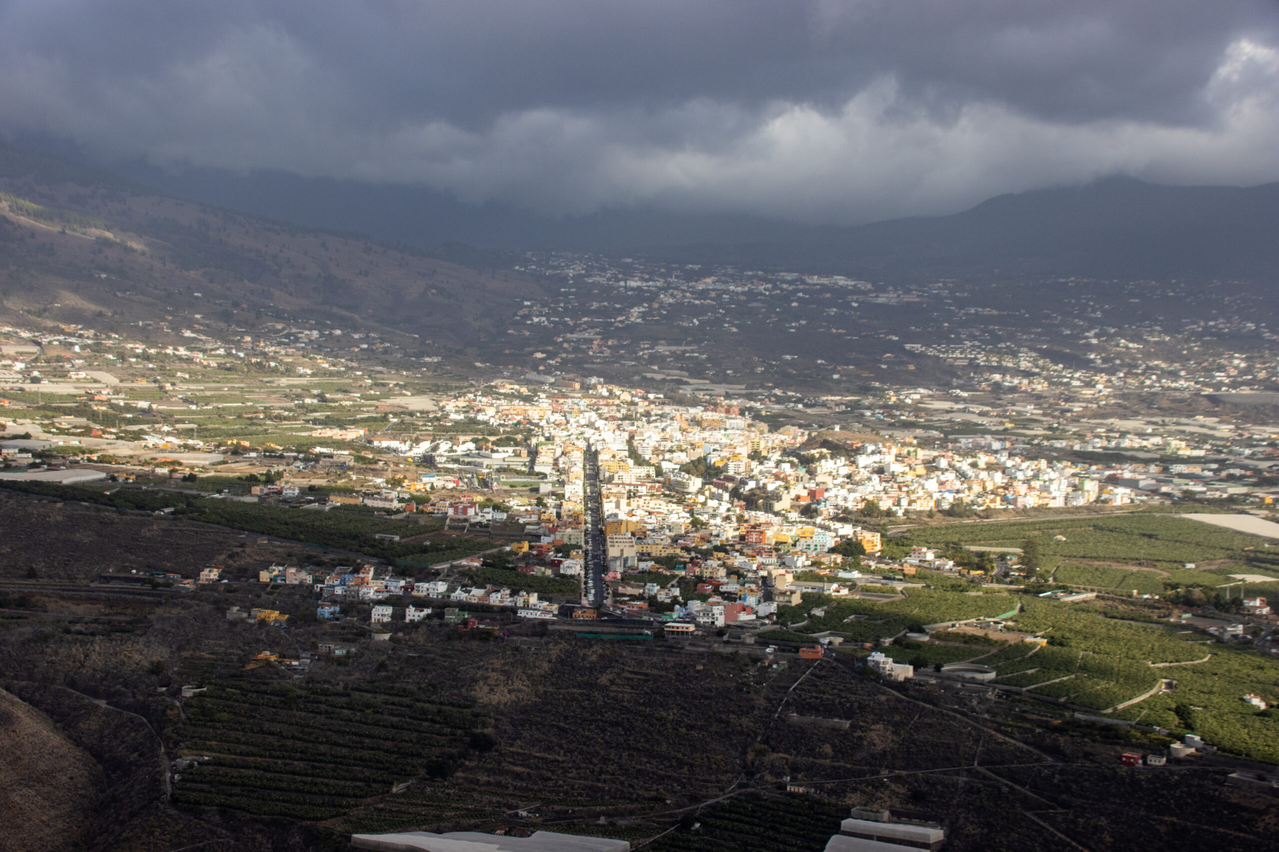 The town of Tazacorte spreads across La Palma's coastal valley, framed by volcanic terrain and agricultural terraces visible from Mirador del Time.