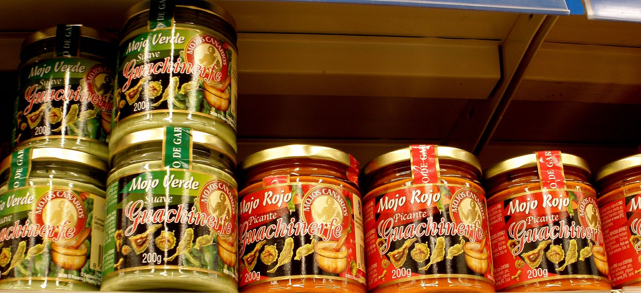 Local mojo sauces—the iconic green (Mojo Verde) and red (Mojo Rojo) varieties—are staples of Canarian cuisine available at shops and markets throughout the islands.