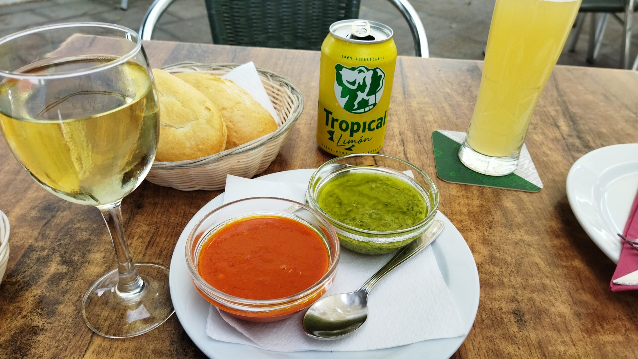 Traditional Canarian mojos—vibrant red and green sauces—served at a casual dining table with local refreshments.