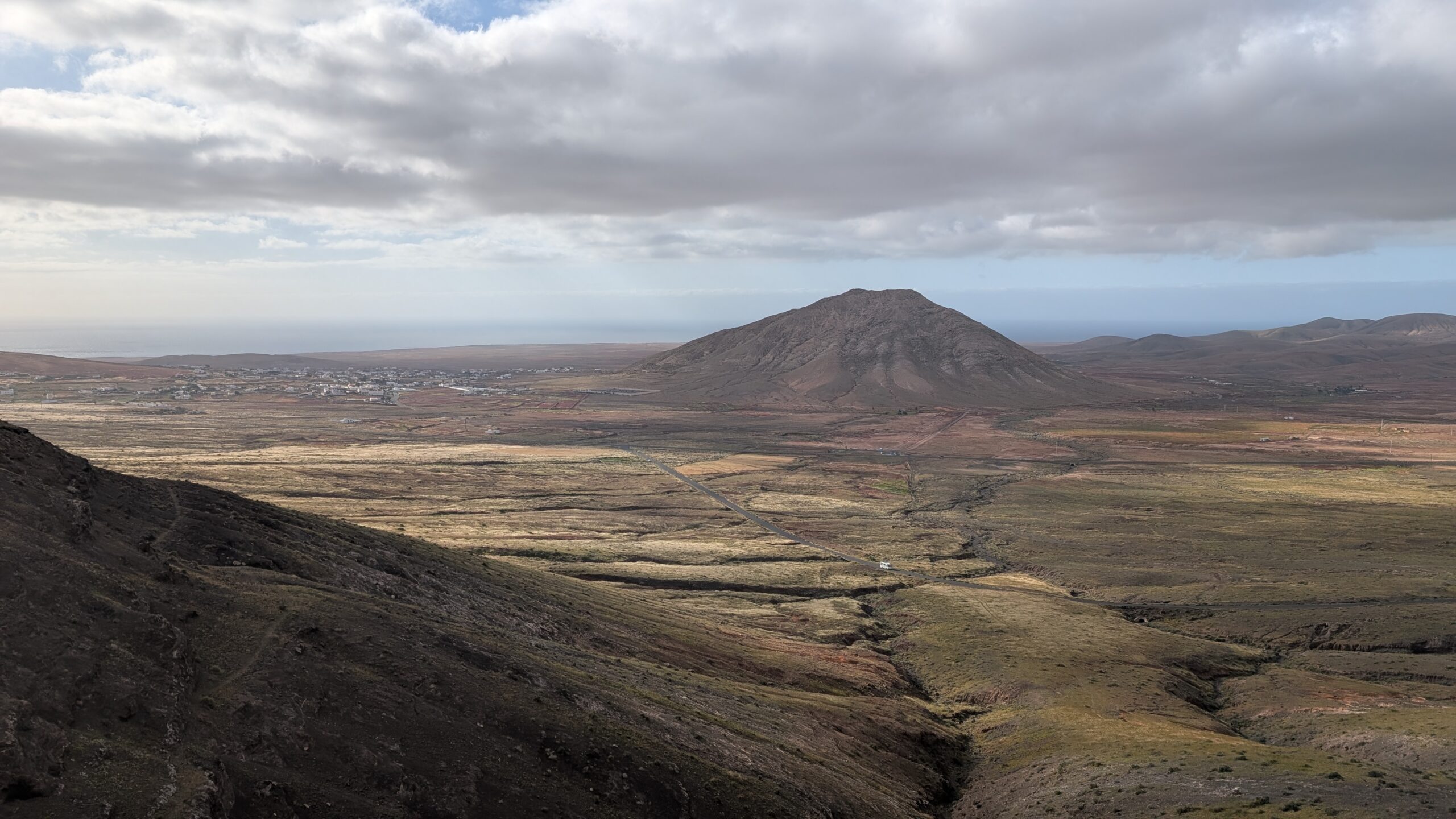 Montaña de Tindaya dominates the landscape of Fuerteventura, its distinctive volcanic cone visible across the island's volcanic terrain.