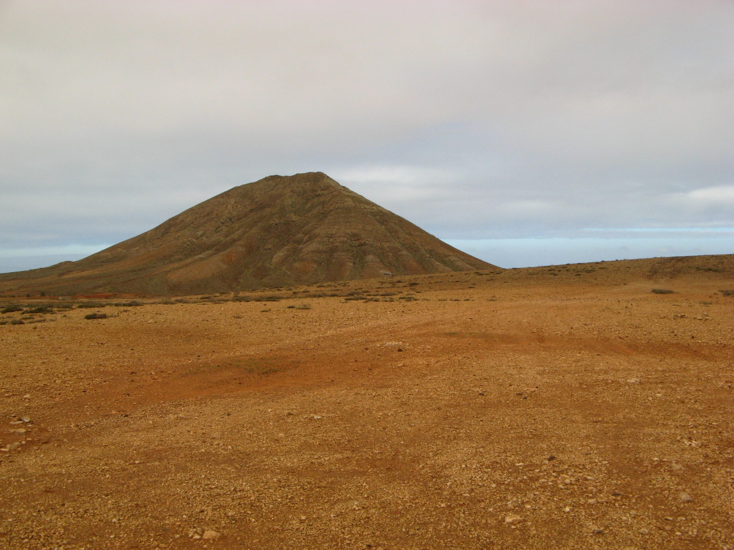 Montaña de Tindaya dominates the sparse, arid plateau of central Fuerteventura with its distinctive conical volcanic profile.