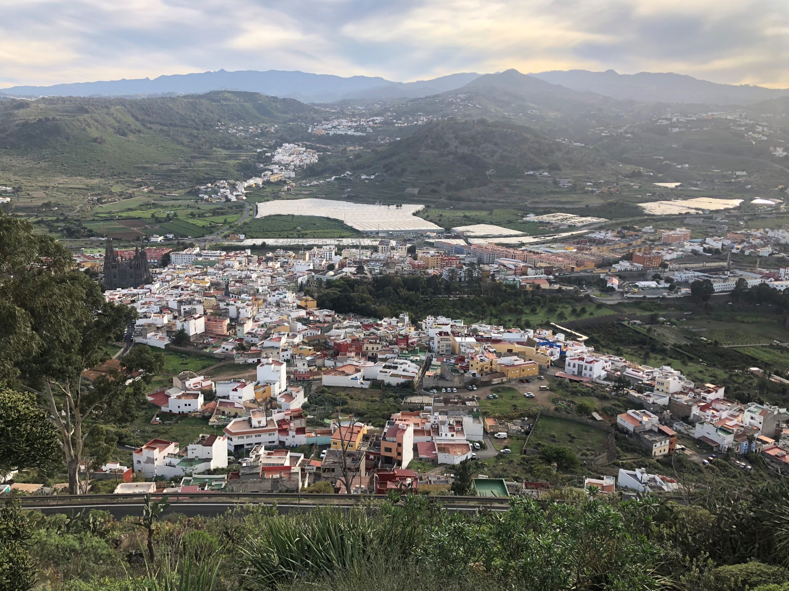 Arucas lies across a fertile valley surrounded by agricultural terraces and distant volcanic peaks.