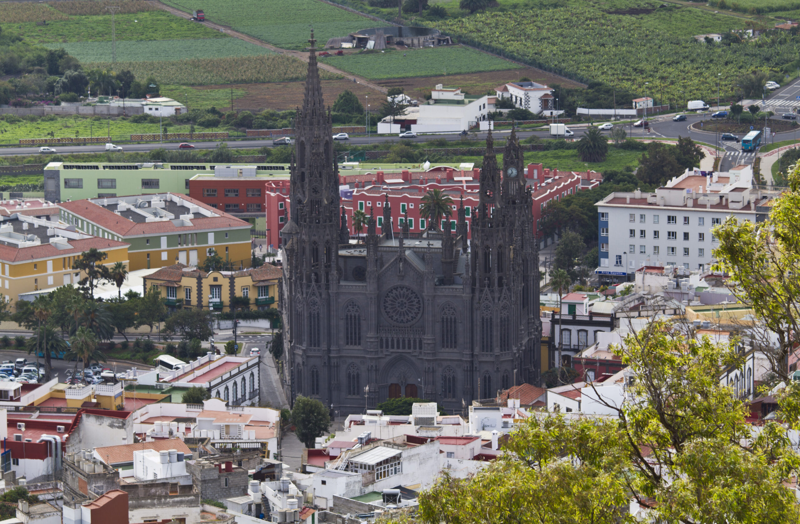 The twin‑spired church of Arucas rises prominently above the town, framed by surrounding farmland and volcanic terrain.