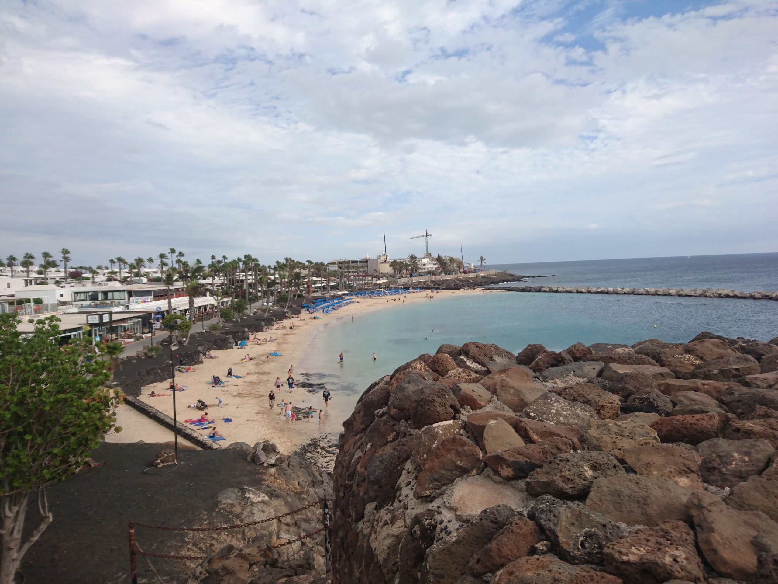 Playa Flamingo's sheltered cove offers golden sand, clear turquoise waters, and a lively beachfront lined with palms and local establishments.