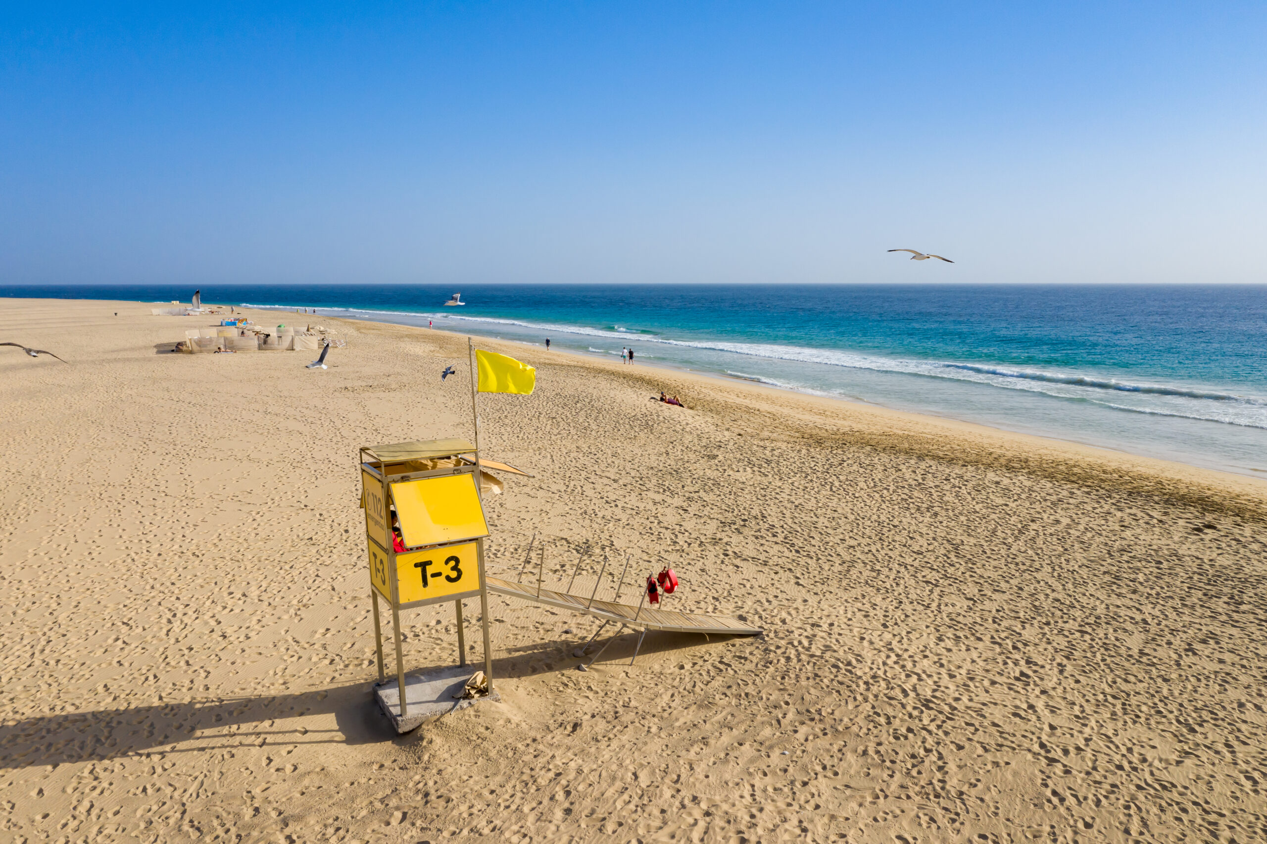 Playa Morro Jable's wide sandy shore features a staffed lifeguard station and calm waters ideal for swimming.