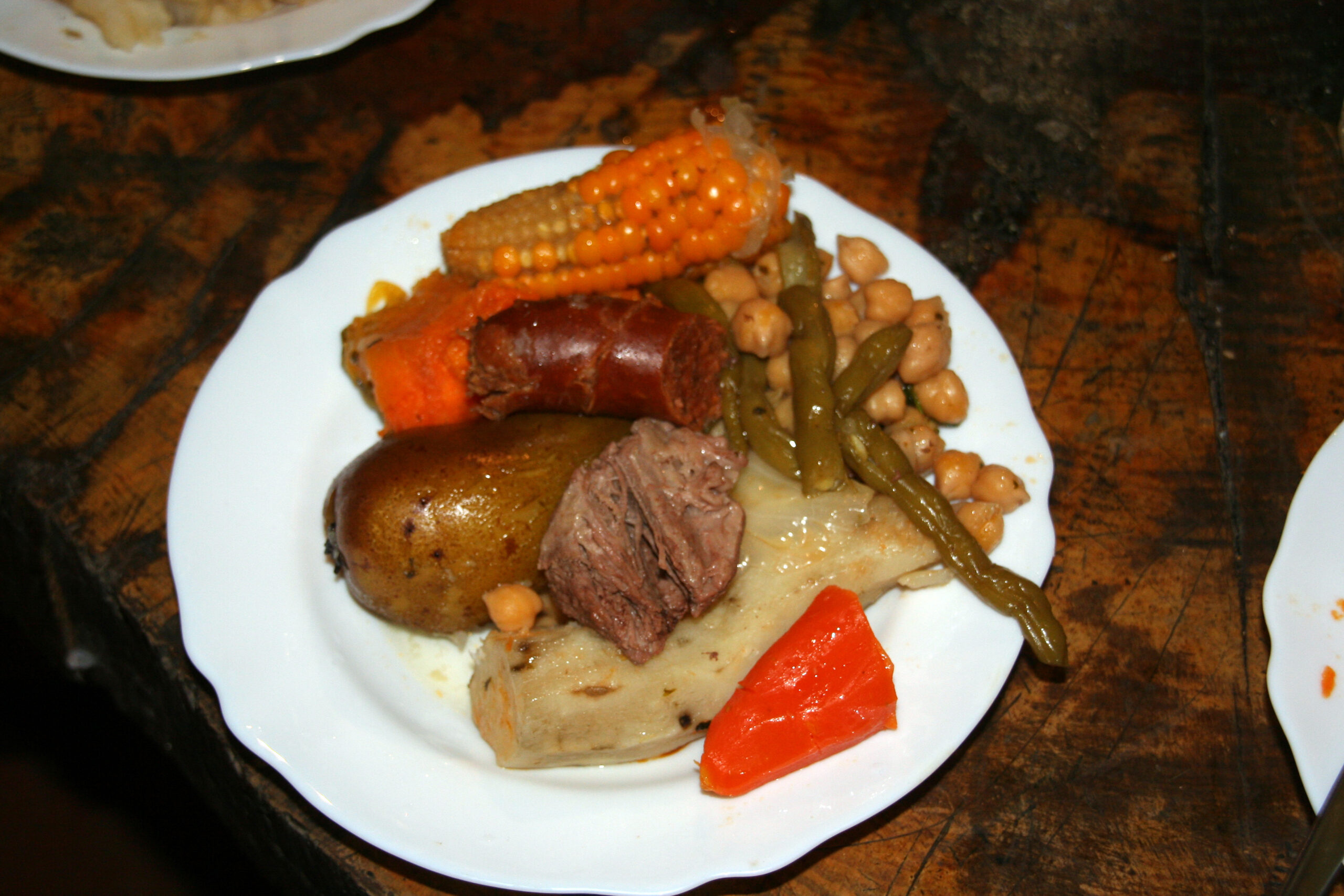 Puchero canario, a traditional Canary Islands stew featuring beef, chorizo, vegetables, and legumes served on a single plate.
