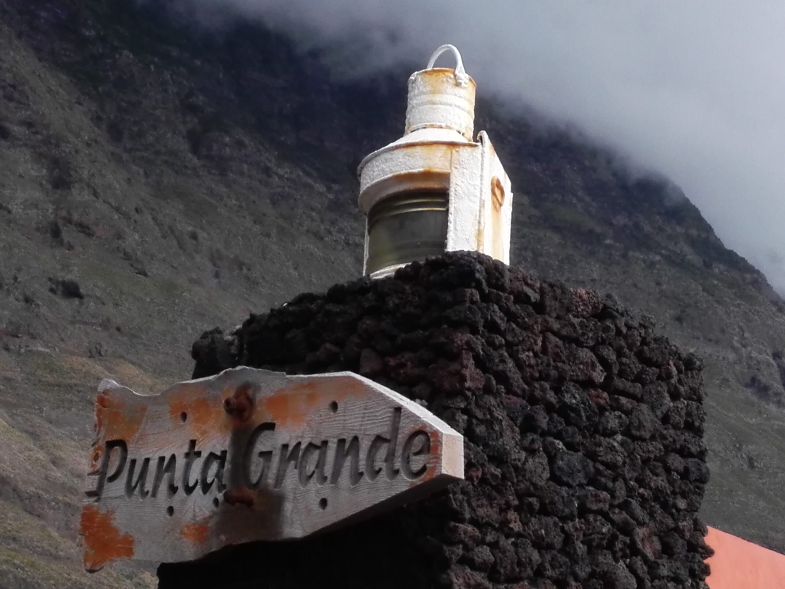 The historic lighthouse beacon at Punta Grande, perched on volcanic rock overlooking the rugged coastline of El Hierro.