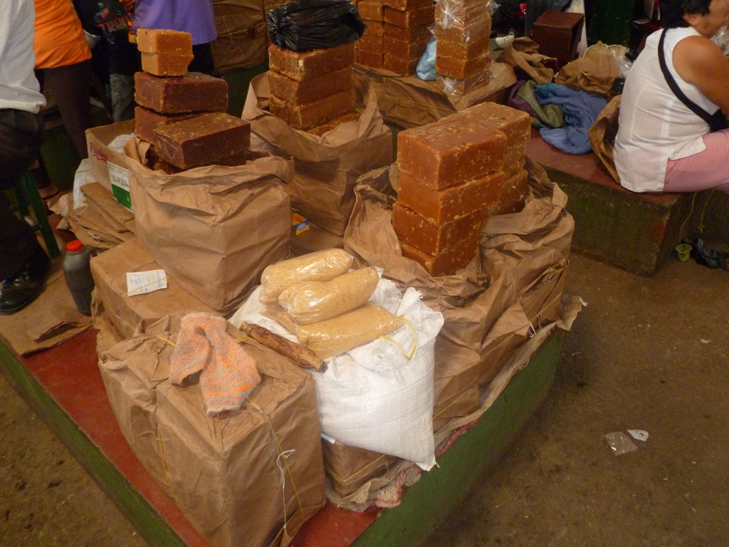 Rapadura canaria, a traditional dark brown cane sugar candy, arranged for sale at a local market.