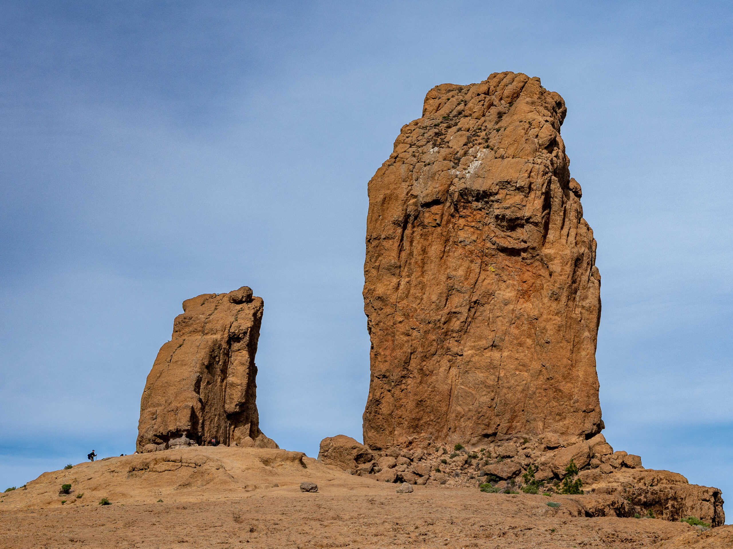 Roque Nublo's distinctive twin rock monoliths stand prominently above the arid landscape of Tejeda, Gran Canaria.
