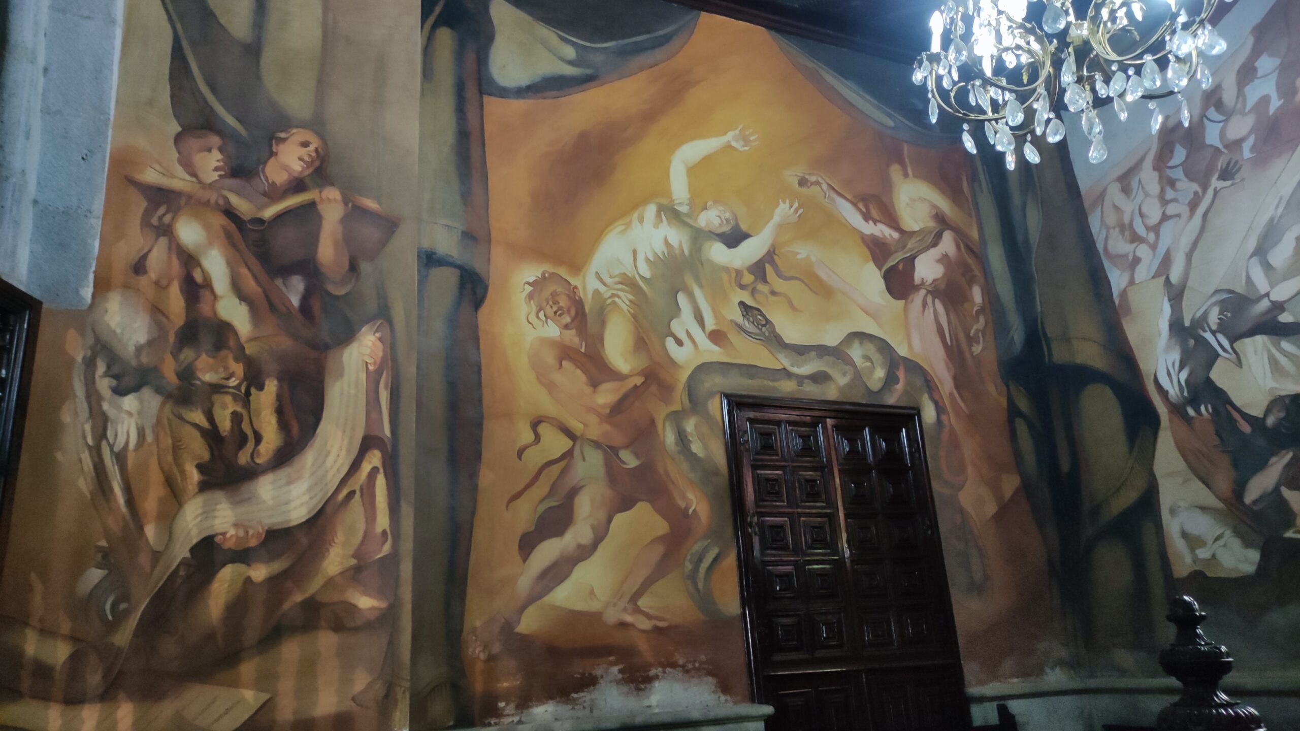 Ornate Baroque frescoes adorn the ceiling of San Juan Church, showcasing classical religious and mythological imagery characteristic of colonial-era religious architecture.