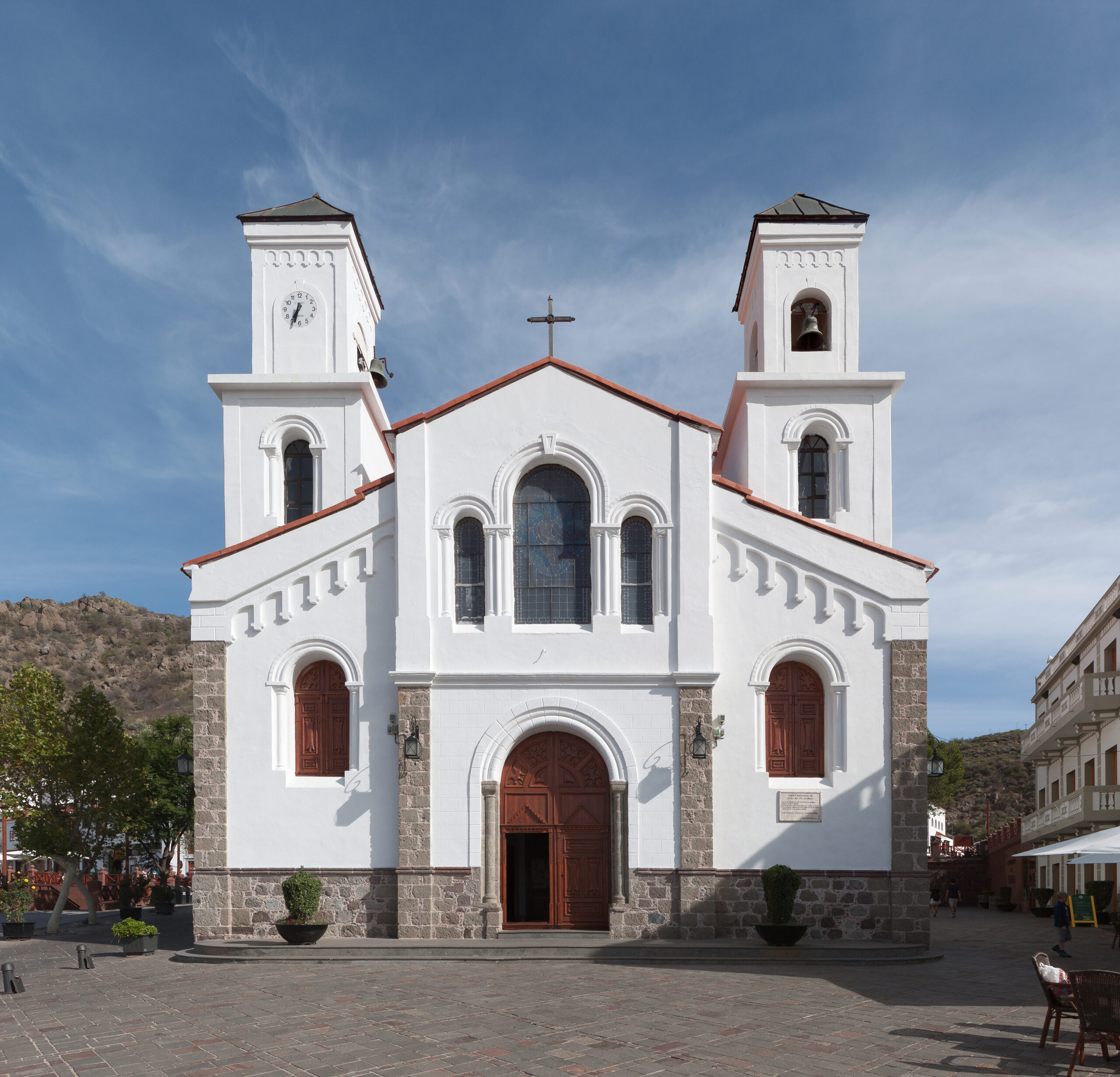 The parish church in Tejeda village features distinctive twin towers and whitewashed walls contrasting with volcanic stone foundations.