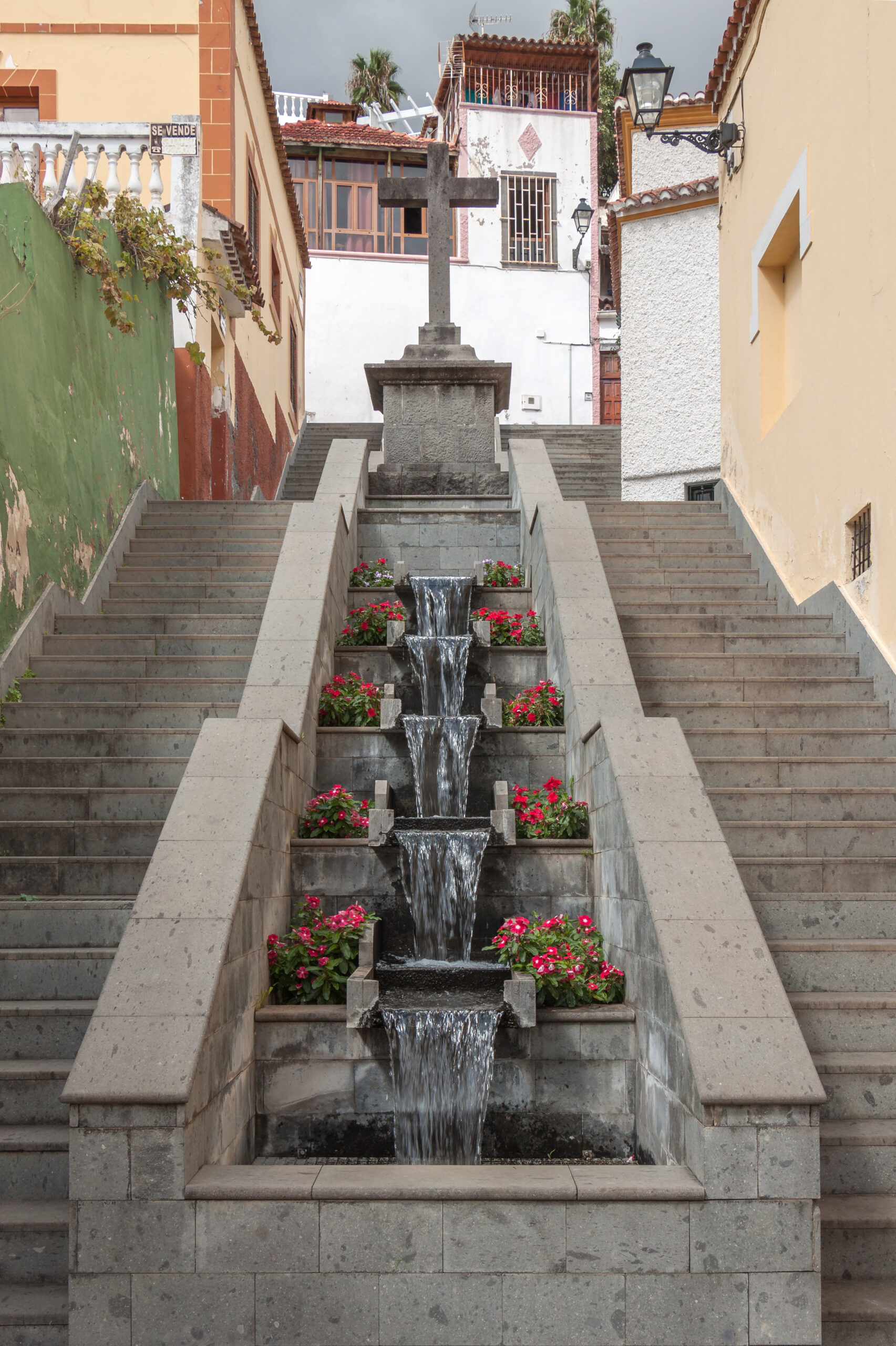 A picturesque stone staircase with flowing water channels and flowering plants leads upward through Teror’s historic centre.