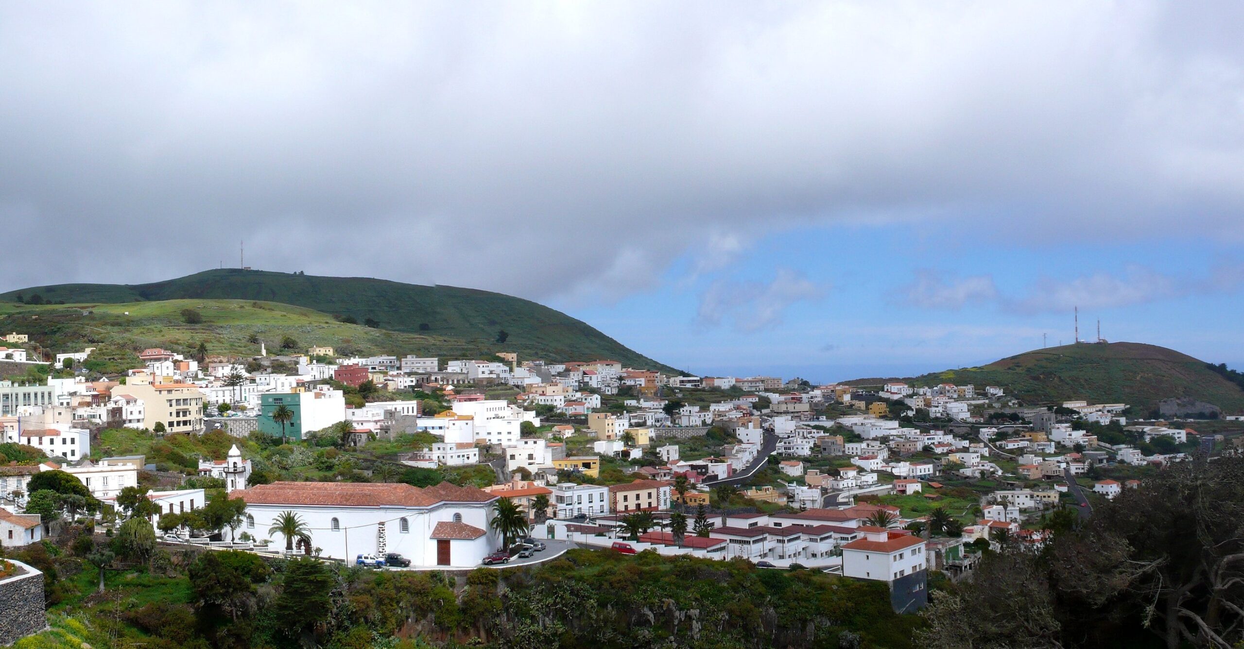 Valverde's old town spreads across the verdant hills of El Hierro, with traditional architecture and volcanic peaks rising beyond.