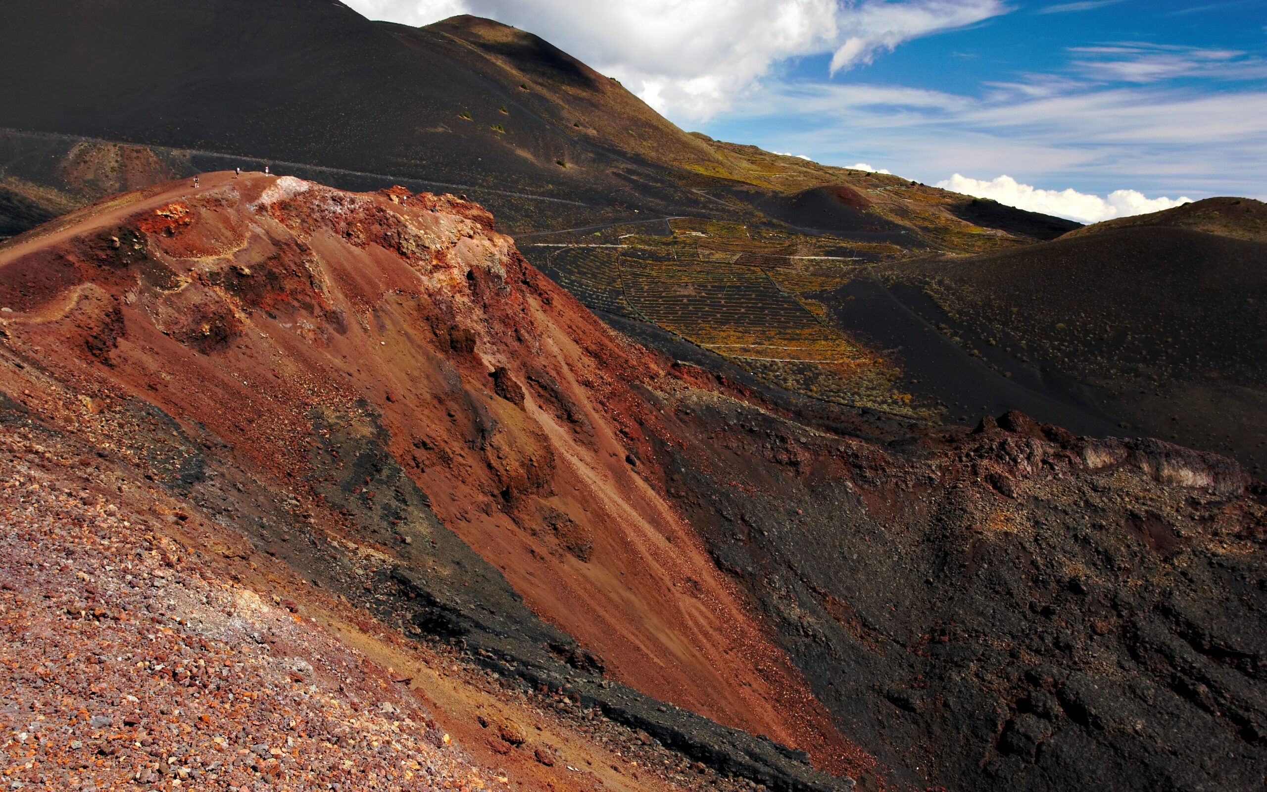 The distinctive red and black cinder cones of Volcán de Teneguía showcase the raw volcanic geology of La Palma's youngest eruption.